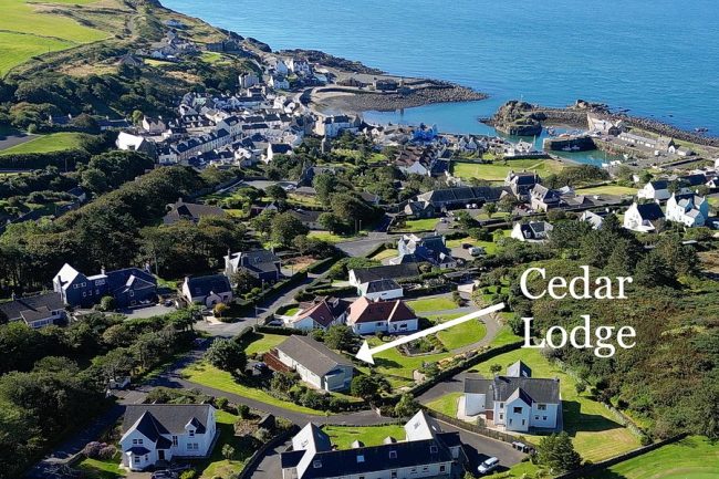Aerial shot of the village of Portpatrick with arrow indicating where Cedar Lodge is located