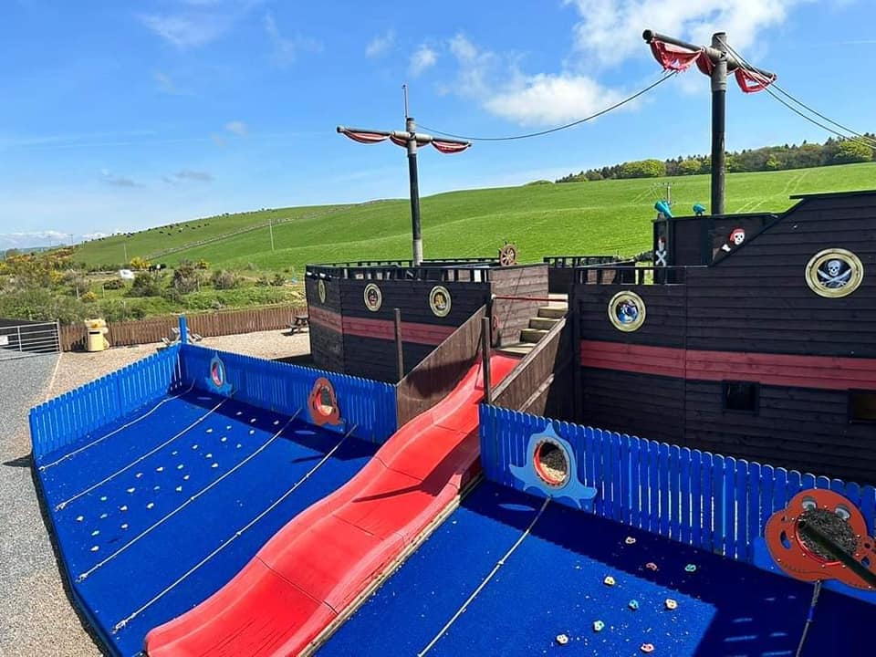 A pirate ship with a red slide in the adventure playground at the Cocoabean
