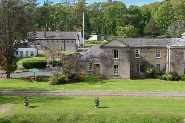 Garden Cottage - the west wing of Corsewall House with a lawn, shrubs and garden furniture