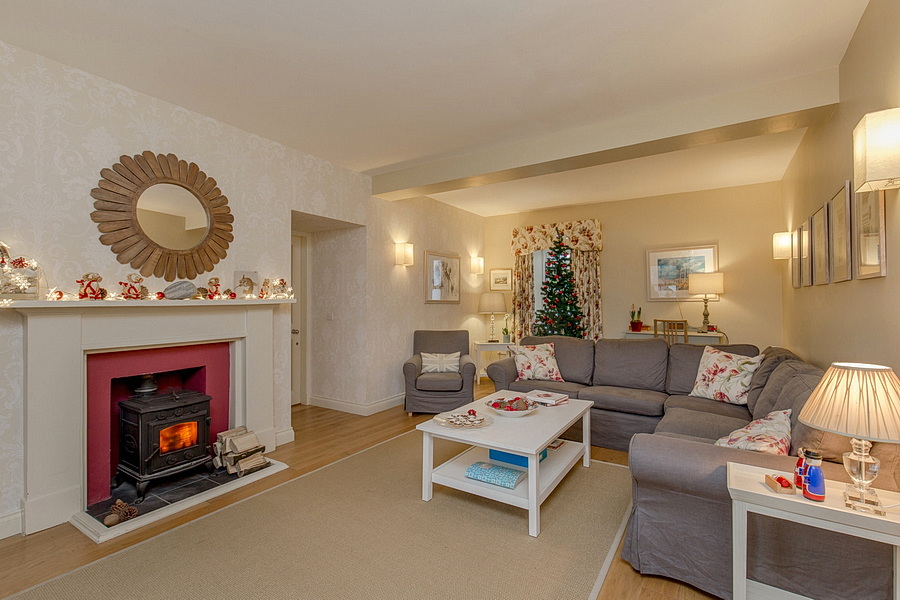 High Clachan Farmhouse for 8 people is available for Christmas now with 20% off. Log burning stove with Christmas tree in the background