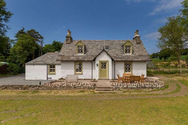 Home Farm Cottage - pretty 'gingerbread' style cottage with a lawn and garden furniture