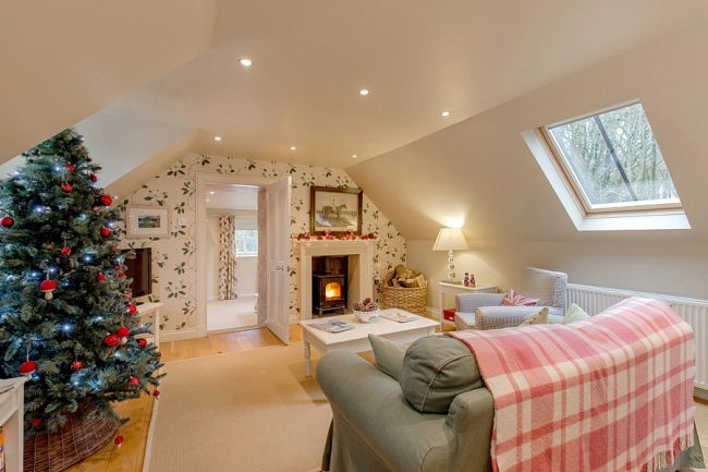 Sitting room with a log burning stove, Christmas tree and Christmas decorations